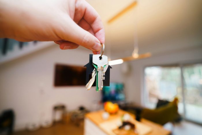 Hand holding house keys, symbolising the right to stay safe at home secured through legal means like an Occupation Order