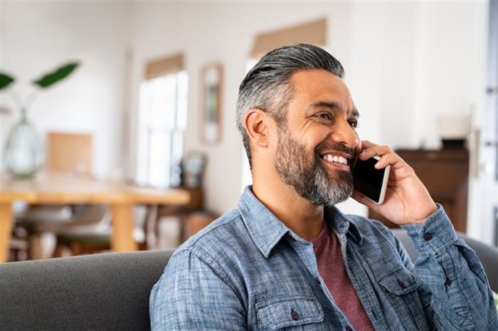Man on mobile phone weighing up whether to go for a free consultation or fixed-fee family law appointment